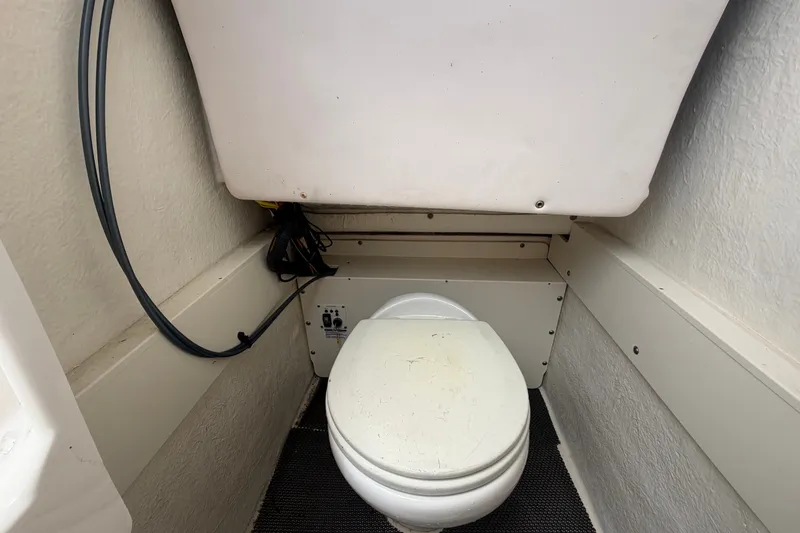Slide: The Image of 2019 Robalo R222 Center Console boat interior with compact marine toilet. - 51
