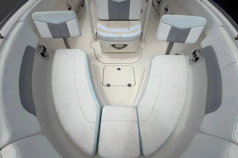 Slide: The Image of 2019 Robalo R222 Center Console boat interior with cushioned seating and storage compartments. - 47