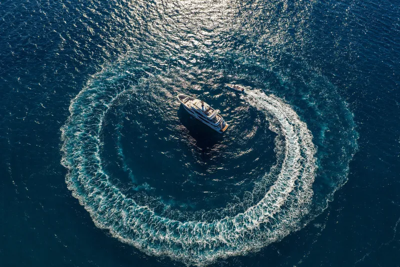 Slide: The Image of Aerial view of 2023 Cantiere Delle Marche RJ 115 yacht creating circular wake in ocean. - 70