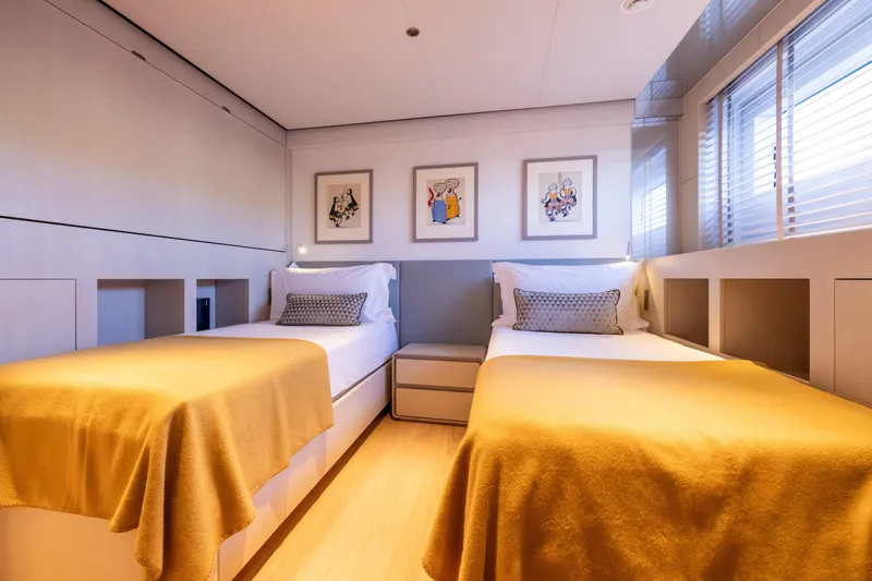Slide: The Image of Luxurious twin bedroom on 2023 Cantiere Delle Marche RJ 115 yacht, featuring modern decor and artwork. - 25