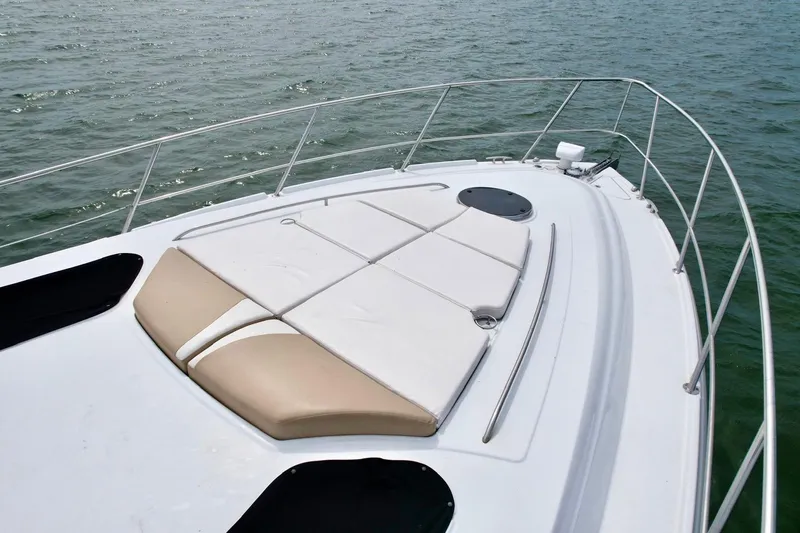 Slide: The Image of 2009 Four Winns V458 yacht deck with sun pads on calm water. - 13