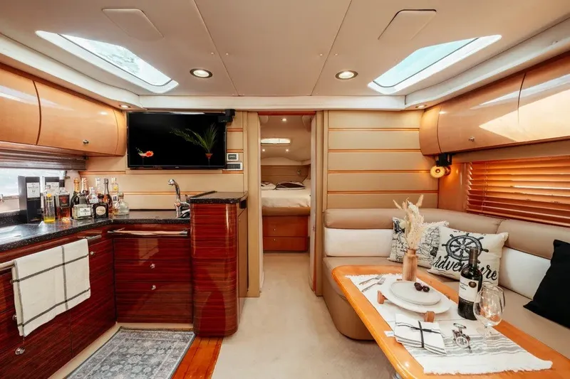 Slide: The Image of Luxurious 2009 Four Winns V458 yacht interior with elegant seating, kitchenette, and decor. - 18