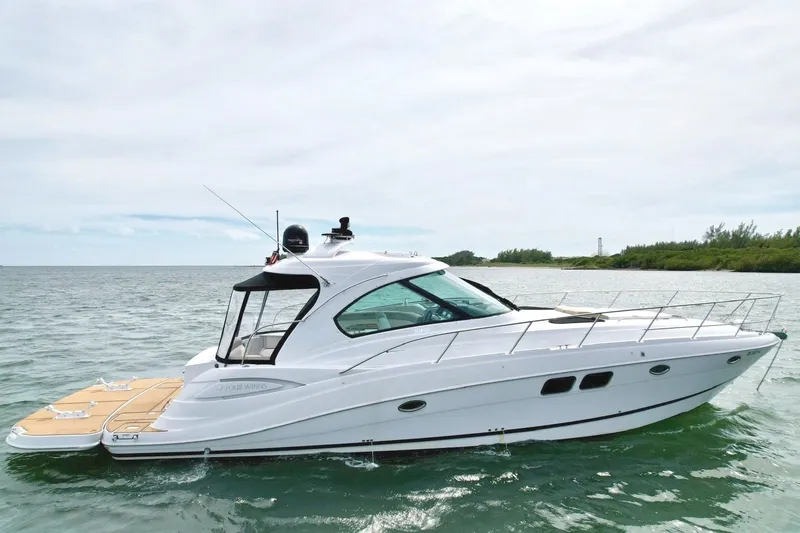 Slide: The Image of 2009 Four Winns V458: Sleek white yacht on calm water with spacious deck and modern lines. - 1