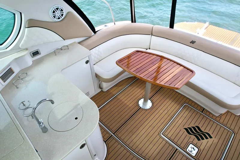 Slide: The Image of Luxurious 2009 Four Winns V458 yacht interior with elegant seating and wooden table. - 34