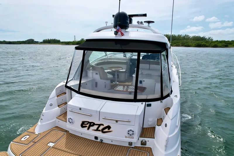 Slide: The Image of 2009 Four Winns V458 yacht on water, rear view with "EPIC" name displayed. - 8