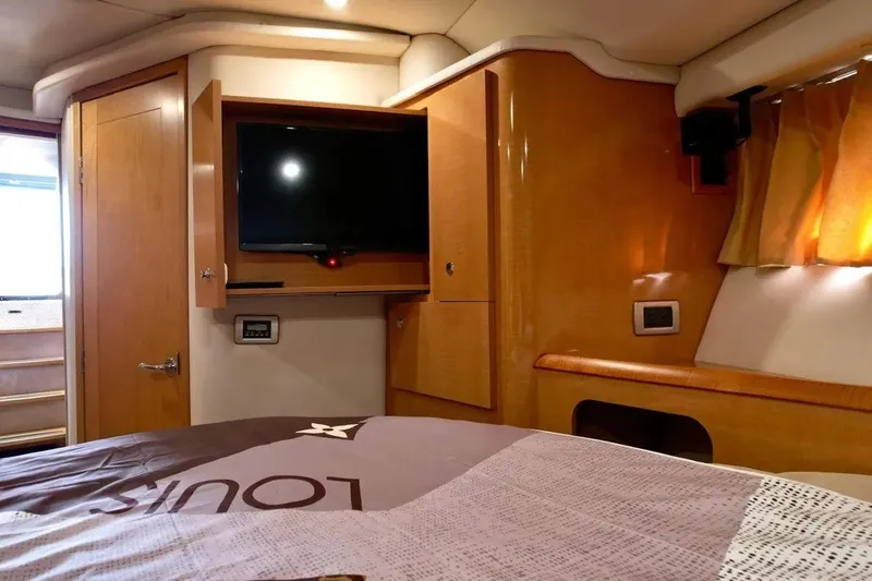 Slide: The Image of Luxurious 2009 Four Winns V458 yacht interior with TV and wooden cabinetry. - 24