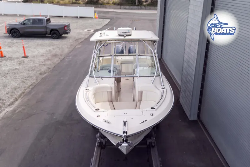 Slide: The Image of 2014 Grady-White Freedom 275 boat on trailer near garage. - 3