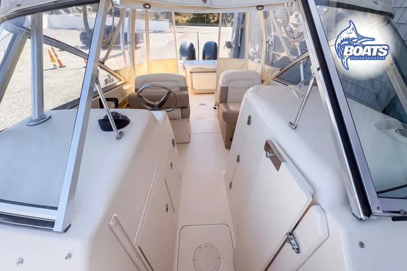 Slide: The Image of 2014 Grady-White Freedom 275 boat interior with seating and steering wheel. - 7