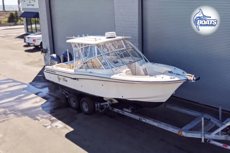 Slide: The Image of 2014 Grady-White Freedom 275 boat on trailer outside a building. - 2
