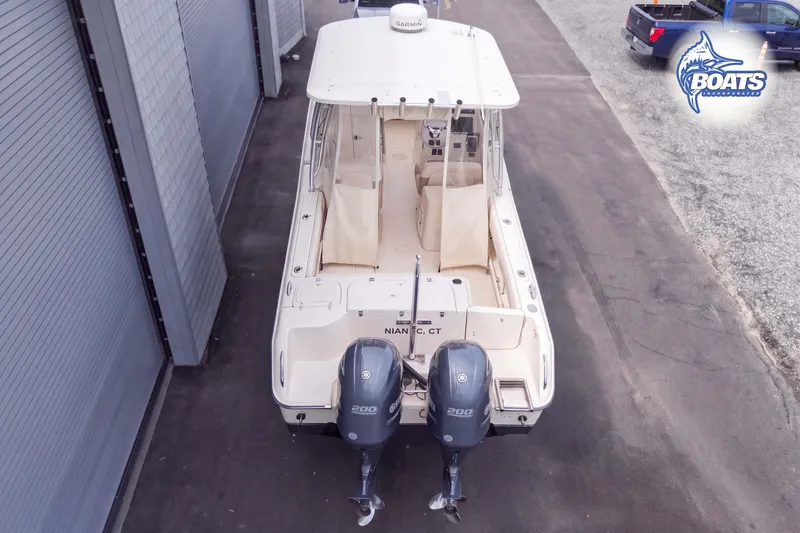 Slide: The Image of 2014 Grady-White Freedom 275 boat with twin Yamaha engines, parked on pavement. - 17