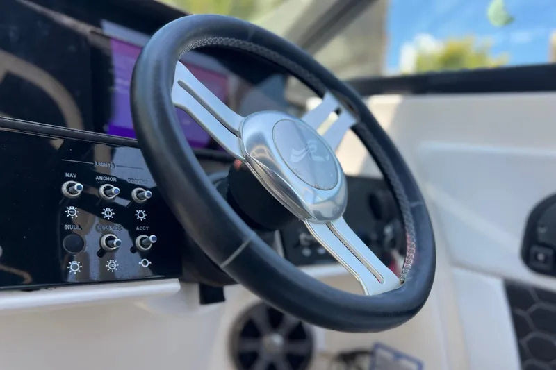 Slide: The Image of Steering wheel and controls of 2019 Sea Ray SDX 270 Outboard boat. - 85