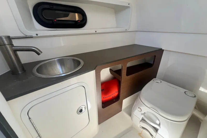 Slide: The Image of Interior of 2019 Sea Ray SDX 270 Outboard boat with sink and portable toilet. - 80