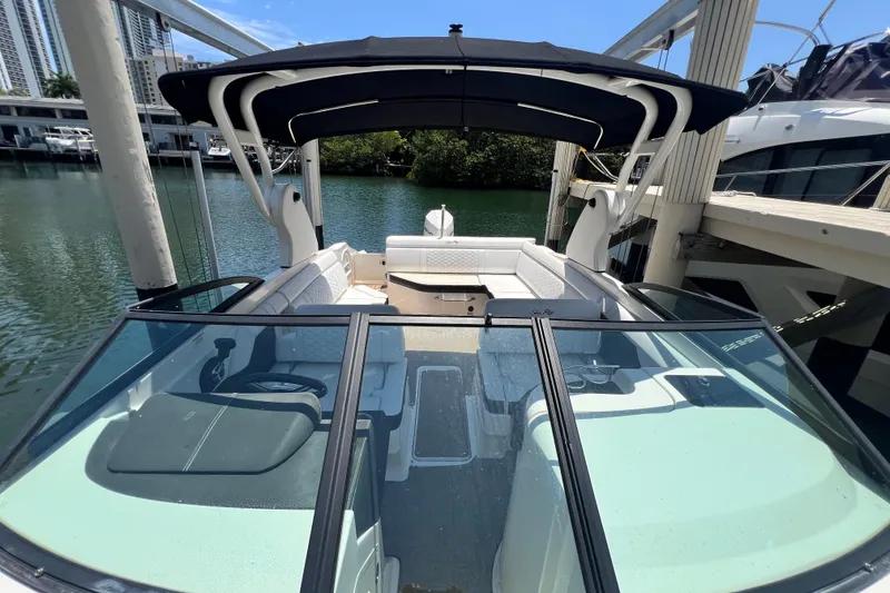Slide: The Image of 2019 Sea Ray SDX 270 Outboard boat docked, featuring spacious seating and sleek design. - 48