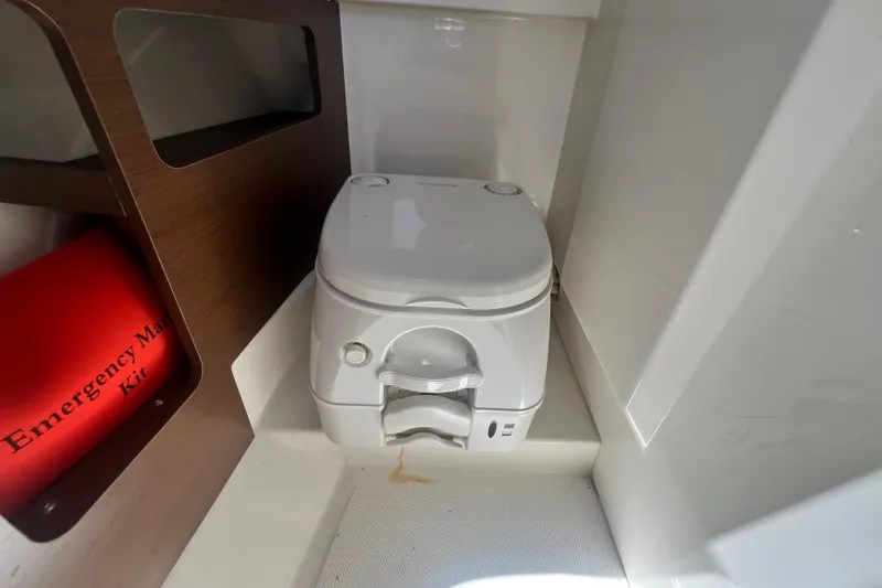 Slide: The Image of Portable toilet and emergency kit inside 2019 Sea Ray SDX 270 Outboard boat. - 81