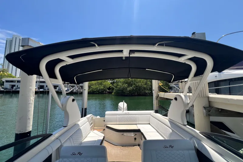 Slide: The Image of 2019 Sea Ray SDX 270 Outboard boat with canopy, docked by the water. - 41