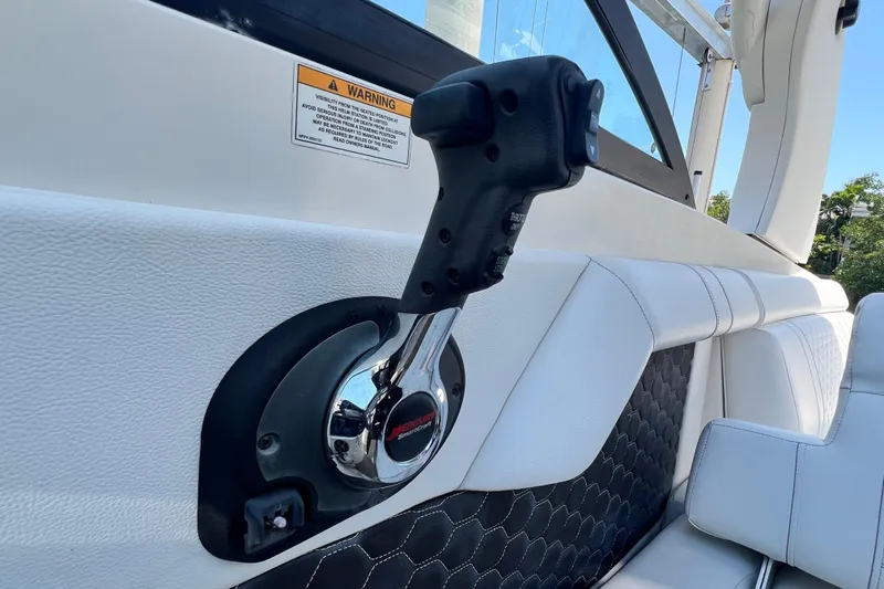 Slide: The Image of Throttle control on 2019 Sea Ray SDX 270 Outboard boat, featuring sleek interior design. - 88