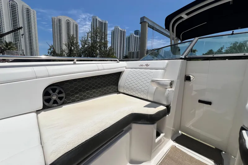 Slide: The Image of 2019 Sea Ray SDX 270 Outboard interior with luxurious seating, city skyline in background. - 50