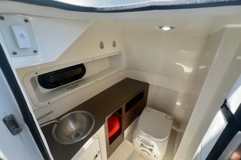 Slide: The Image of 2019 Sea Ray SDX 270 Outboard interior with sink and portable toilet. - 82