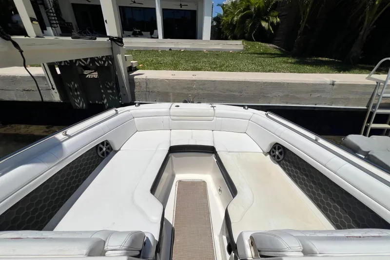 Slide: The Image of 2019 Sea Ray SDX 270 Outboard boat interior with white seating and hexagonal accents. - 65