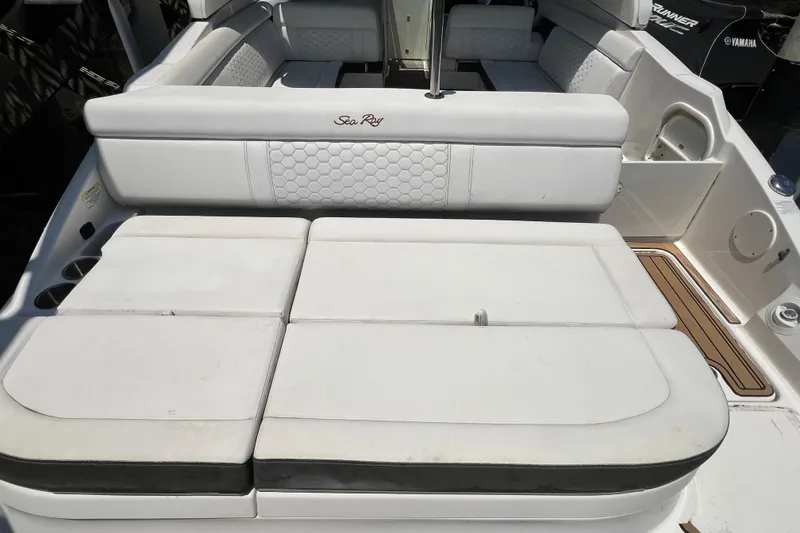 Slide: The Image of 2019 Sea Ray SDX 270 Outboard boat interior with white cushioned seating. - 93