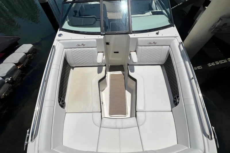 Slide: The Image of 2019 Sea Ray SDX 270 Outboard boat interior with white seating and open deck layout. - 53