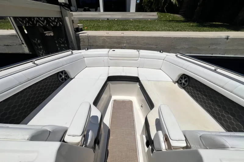 Slide: The Image of 2019 Sea Ray SDX 270 Outboard boat interior with white seating and hexagonal speaker design. - 68