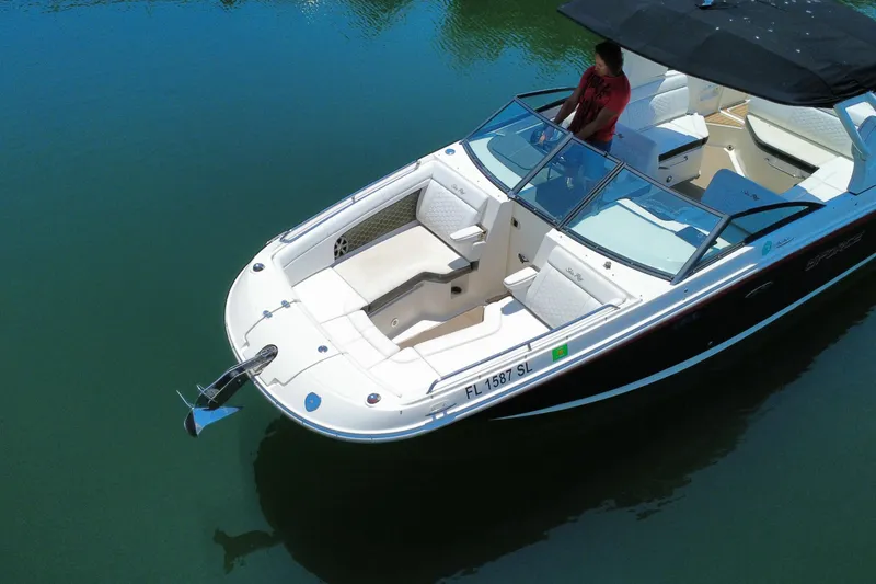Slide: The Image of 2019 Sea Ray SDX 270 Outboard boat on calm water, featuring spacious seating and sleek design. - 18
