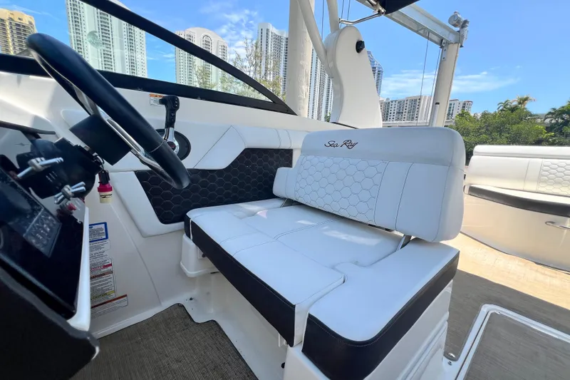 Slide: The Image of 2019 Sea Ray SDX 270 Outboard interior with white seating and steering wheel. - 46