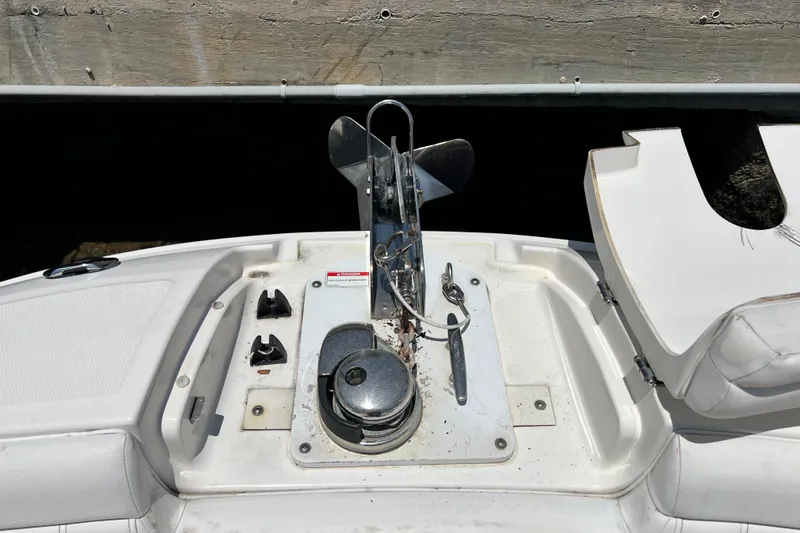Slide: The Image of 2019 Sea Ray SDX 270 Outboard anchor system on white deck, docked by wooden pier. - 59