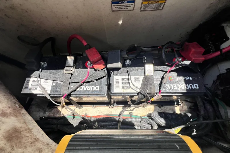 Slide: The Image of Batteries in a 2019 Sea Ray SDX 270 Outboard boat, showing wiring and connections. - 103
