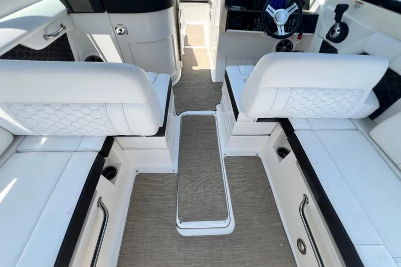 Slide: The Image of Interior of 2019 Sea Ray SDX 270 Outboard with white seating and modern dashboard. - 102