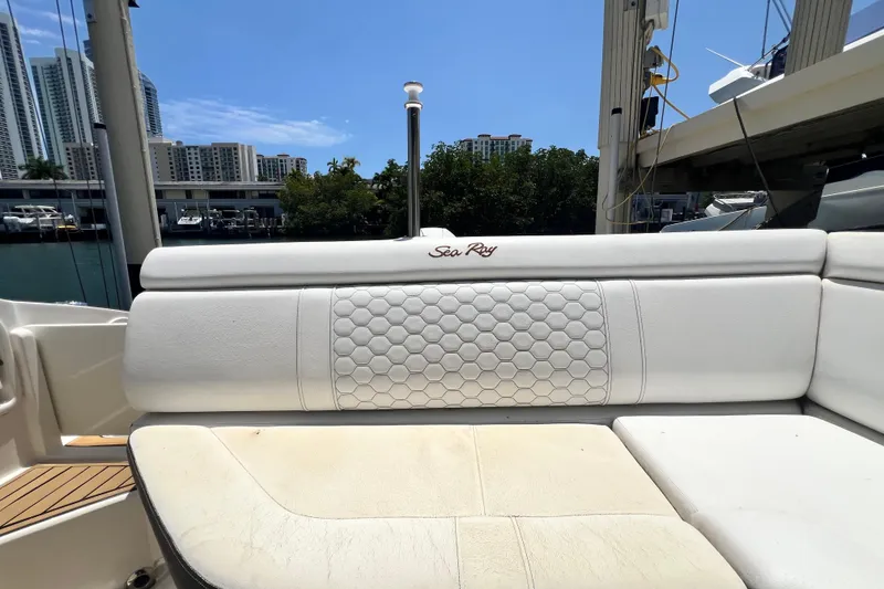 Slide: The Image of 2019 Sea Ray SDX 270 Outboard boat seating with urban skyline backdrop. - 38