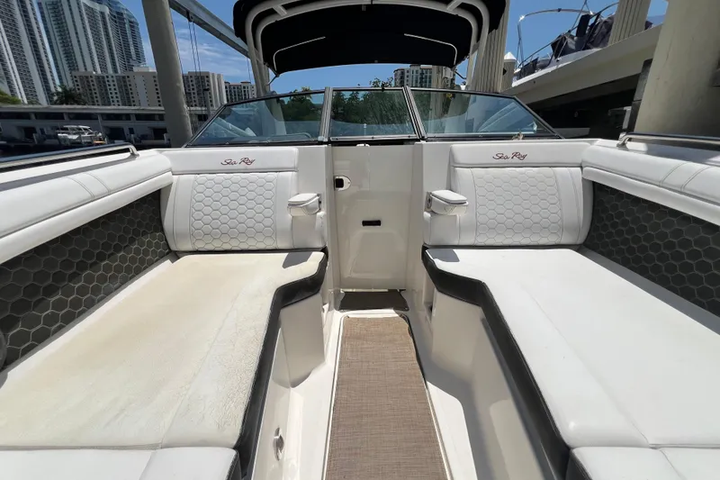 Slide: The Image of 2019 Sea Ray SDX 270 Outboard interior with white seating and hexagonal patterns. - 57