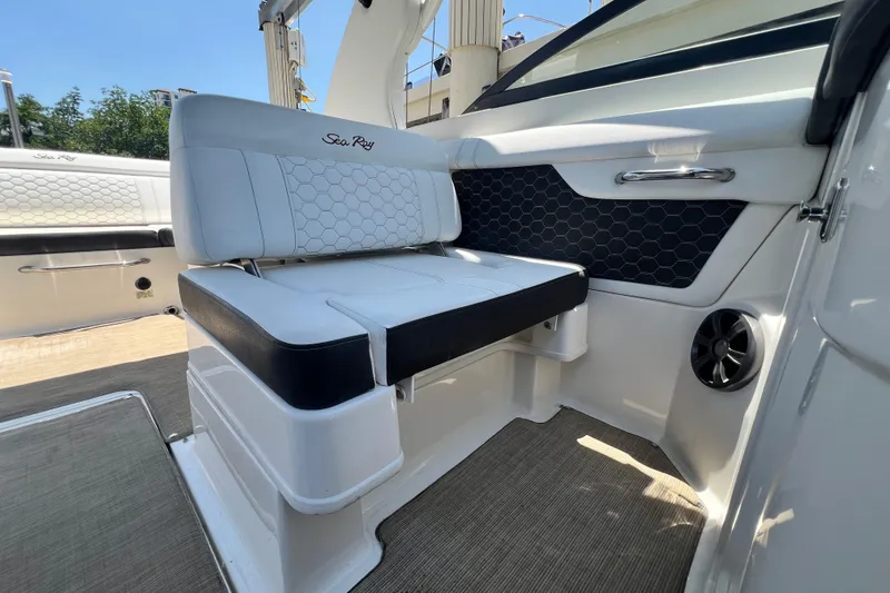 Slide: The Image of 2019 Sea Ray SDX 270 Outboard interior with white seating and hexagonal pattern design. - 47
