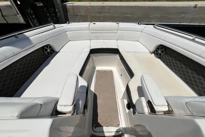 Slide: The Image of 2019 Sea Ray SDX 270 Outboard boat interior with white seating and hexagonal speaker design. - 100