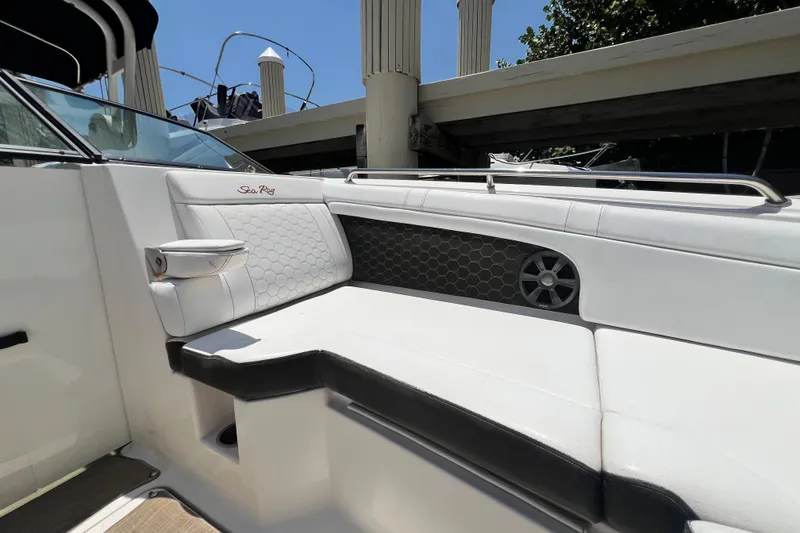 Slide: The Image of 2019 Sea Ray SDX 270 Outboard interior with white seating and speaker detail. - 51