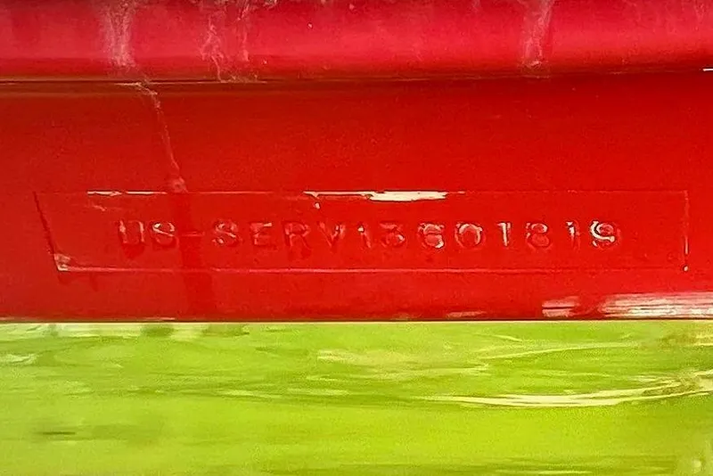 Slide: The Image of 2019 Sea Ray SDX 270 Outboard boat hull in water, showcasing red and white design. - 107