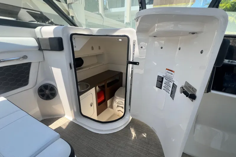Slide: The Image of 2019 Sea Ray SDX 270 Outboard interior cabin with storage and sink. - 78