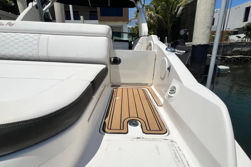 Slide: The Image of 2019 Sea Ray SDX 270 Outboard boat interior with white seating and teak flooring. - 96