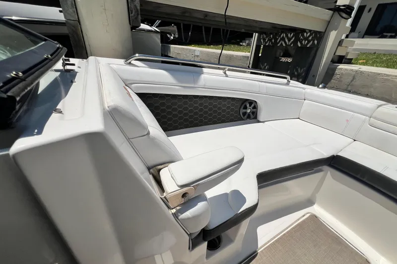 Slide: The Image of 2019 Sea Ray SDX 270 Outboard interior with white seating and speaker detail. - 66