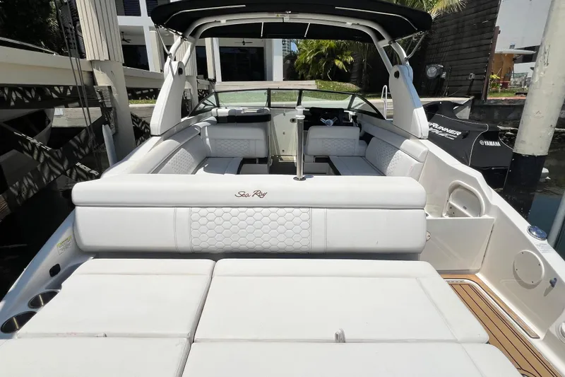 Slide: The Image of 2019 Sea Ray SDX 270 Outboard boat interior with white seating and modern design. - 94