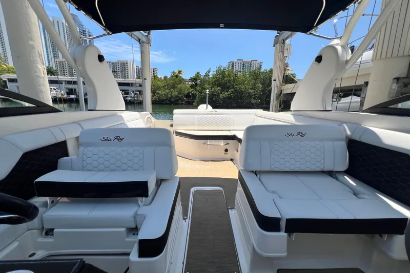 Slide: The Image of 2019 Sea Ray SDX 270 Outboard boat interior with luxurious seating and waterfront view. - 43