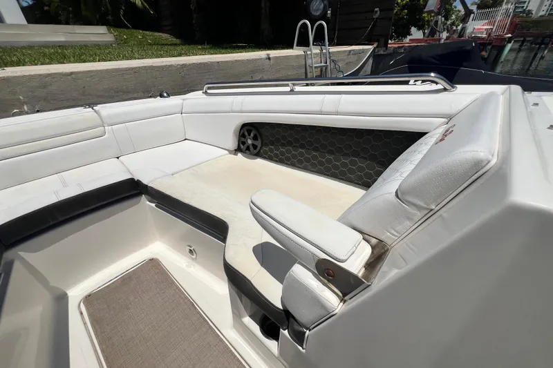 Slide: The Image of 2019 Sea Ray SDX 270 Outboard boat interior with white seating and hexagonal speaker design. - 67
