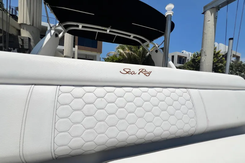 Slide: The Image of 2019 Sea Ray SDX 270 Outboard boat with white upholstery and hexagonal pattern design. - 76