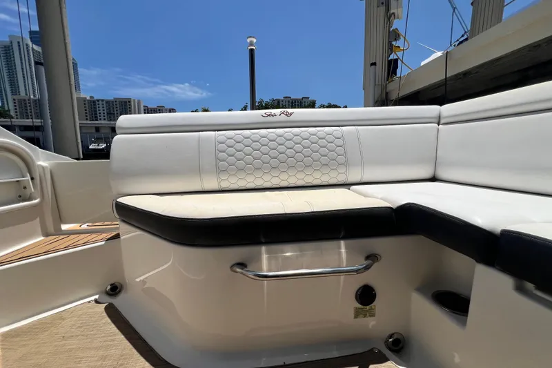 Slide: The Image of 2019 Sea Ray SDX 270 Outboard boat seating with white upholstery and hexagonal pattern. - 33