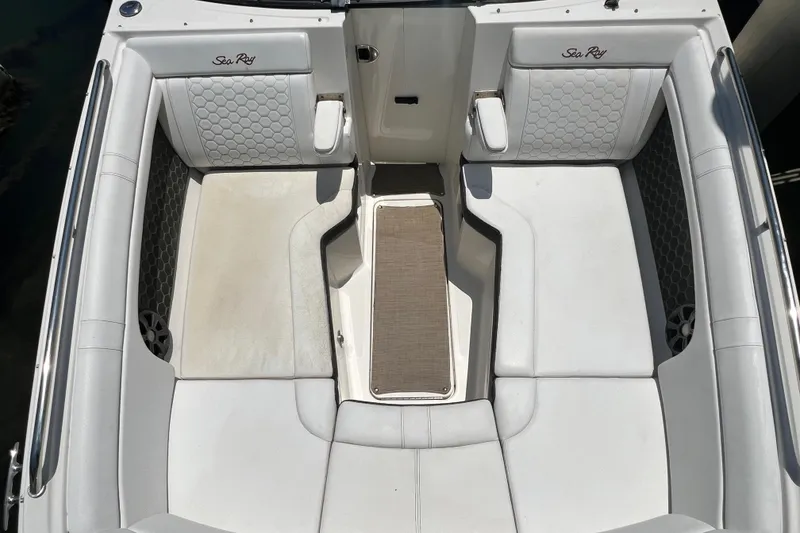Slide: The Image of 2019 Sea Ray SDX 270 Outboard boat interior with white cushioned seating and elegant design. - 54