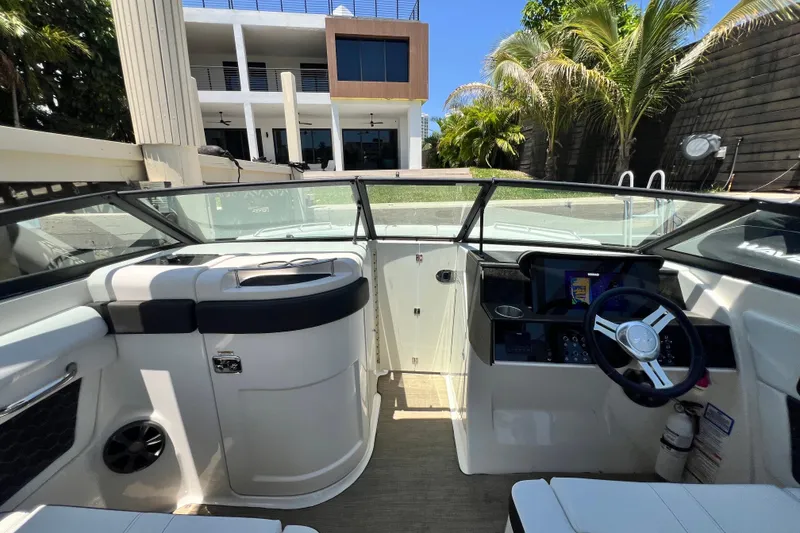 Slide: The Image of Interior view of a 2019 Sea Ray SDX 270 Outboard boat, featuring a modern helm and seating. - 69