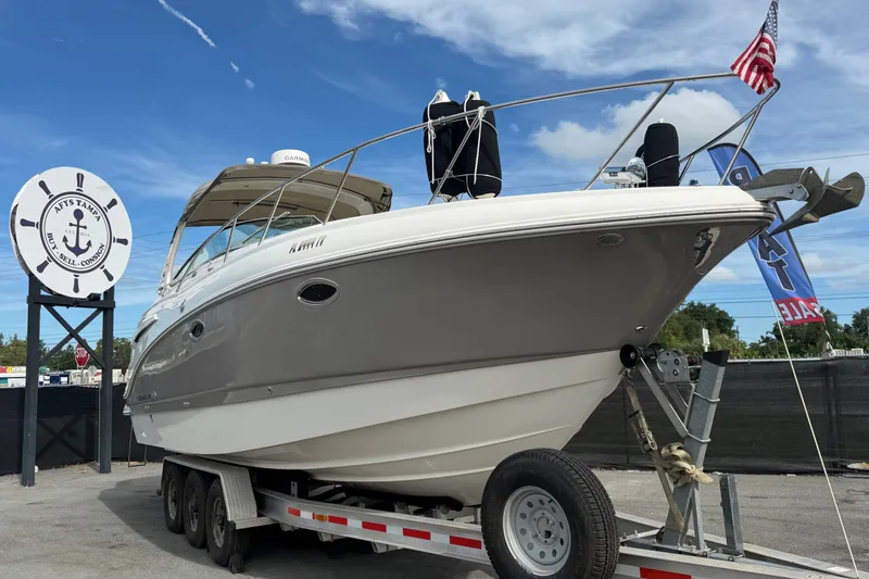 The Image of 2008 Chaparral Signature 290 boat on trailer, displayed outdoors with American flag. - 0