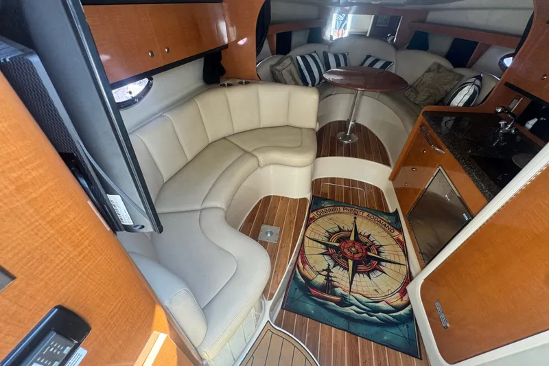 Slide: The Image of Interior of 2008 Chaparral Signature 290 boat with seating, table, and kitchenette. - 23