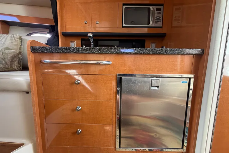 Slide: The Image of 2008 Chaparral Signature 290 interior kitchen with microwave, sink, and fridge. - 78